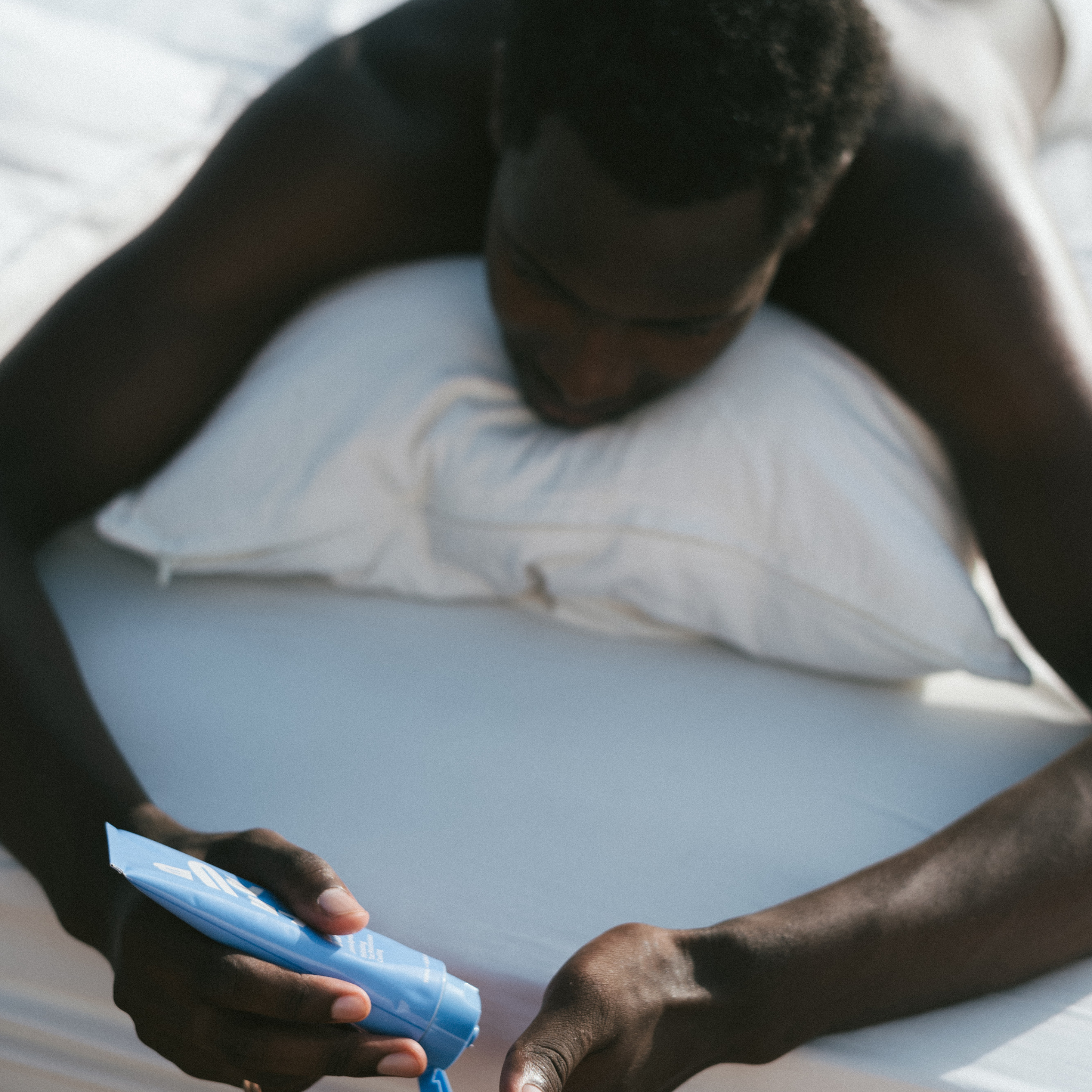 LE RUB Repairing Body Lotion being applied, showcasing intimate skincare moment with minimalist, inclusive aesthetic