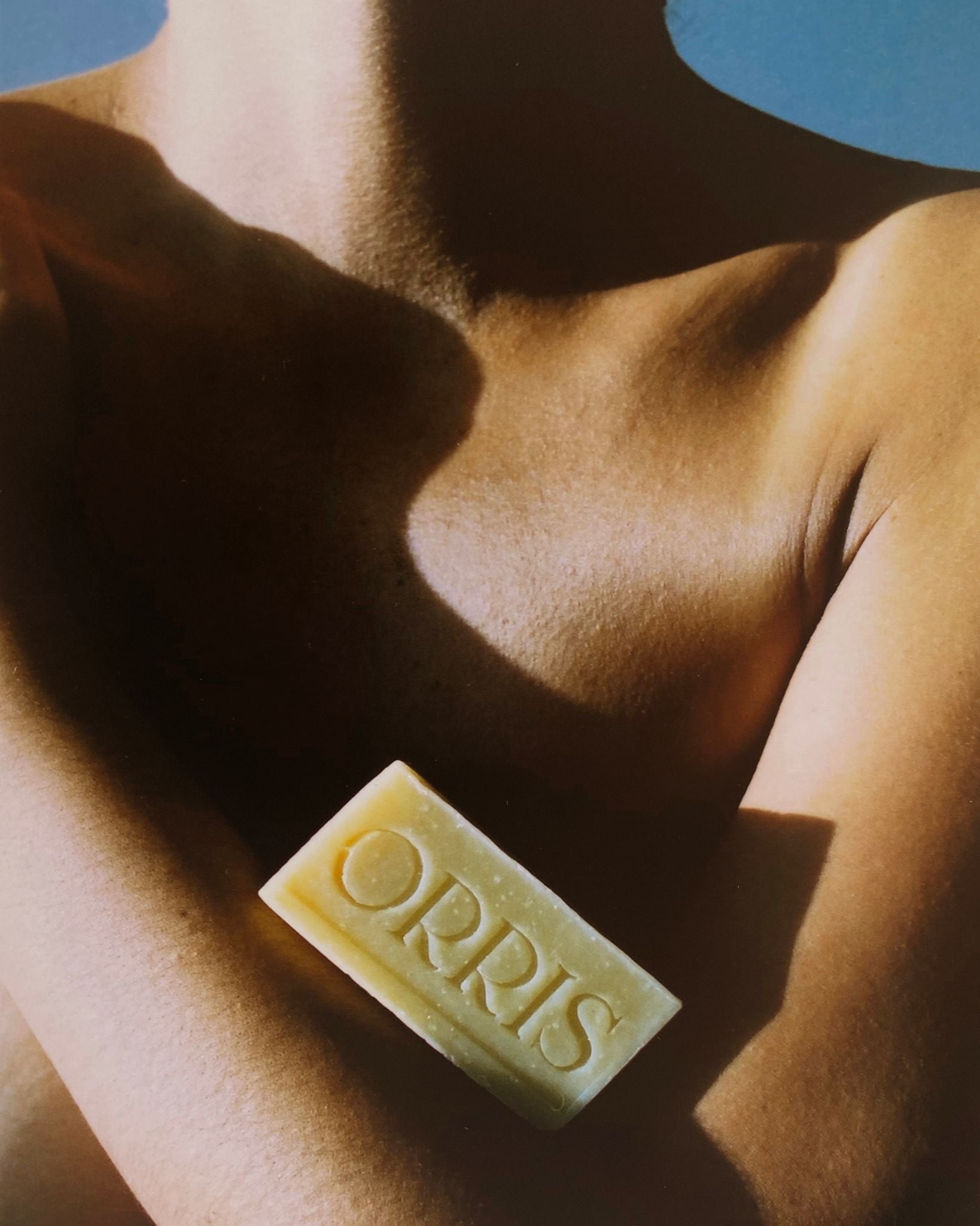 Orris Paris soap lifestyle image - Elegant woman showcasing artisanal soap, embodying the brand's sophisticated French skincare approach and minimalist beauty aesthetic