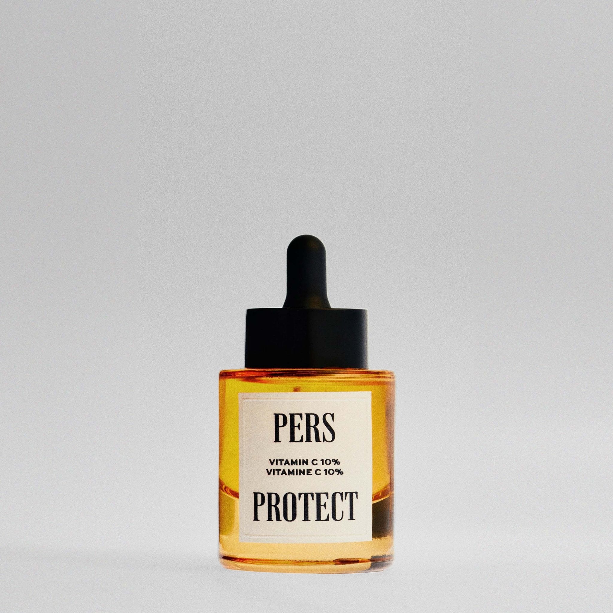 PERS Protect Vitamin C 10% Serum in amber glass bottle with black dropper, showcasing minimalist skincare design with clean typography