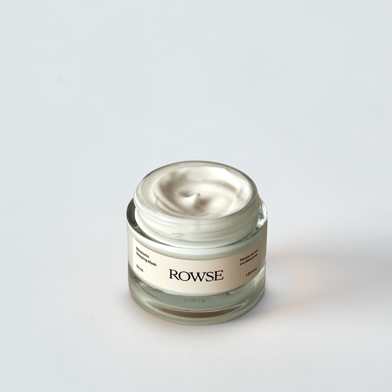 ROWSE Melatonin Sleeping Mask in clear glass jar, showcasing luxurious cream texture and minimalist packaging design