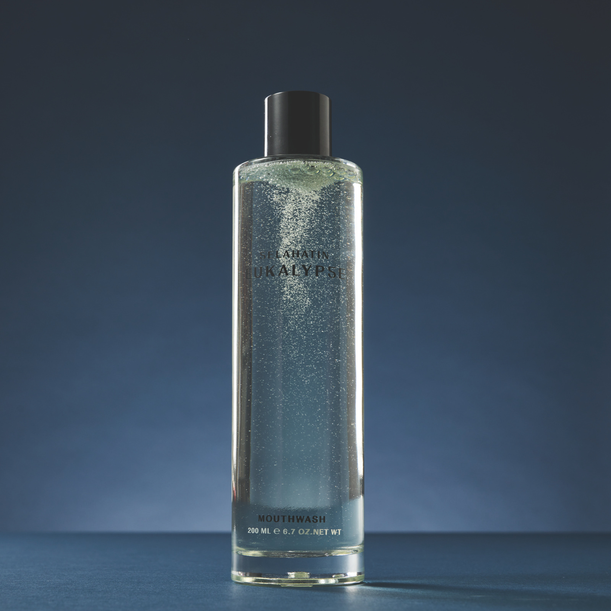 Selahatin Eukalypse mouthwash in clear glass bottle with blue-green liquid, showcasing minimalist design and product details