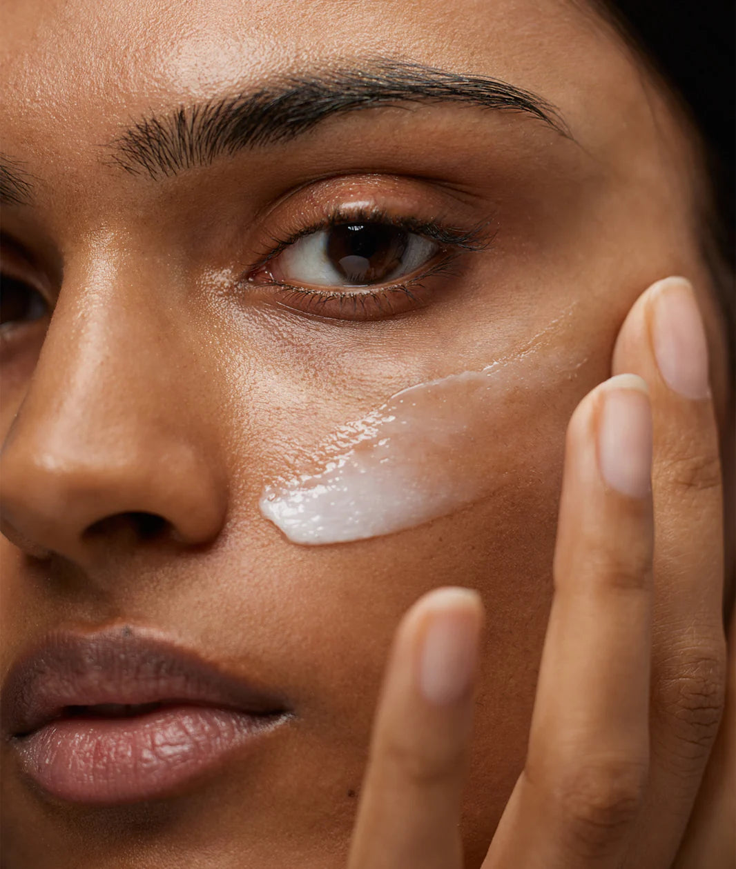 Minimalist clean beauty portrait showcasing natural, radiant skin with soft lighting and understated elegance