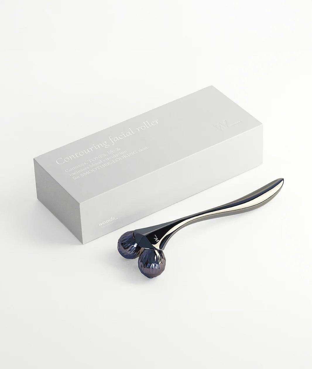 Woods Copenhagen Contouring Facial Roller - minimalist white packaging with sleek metallic roller, showcasing Scandinavian design and advanced skincare technology