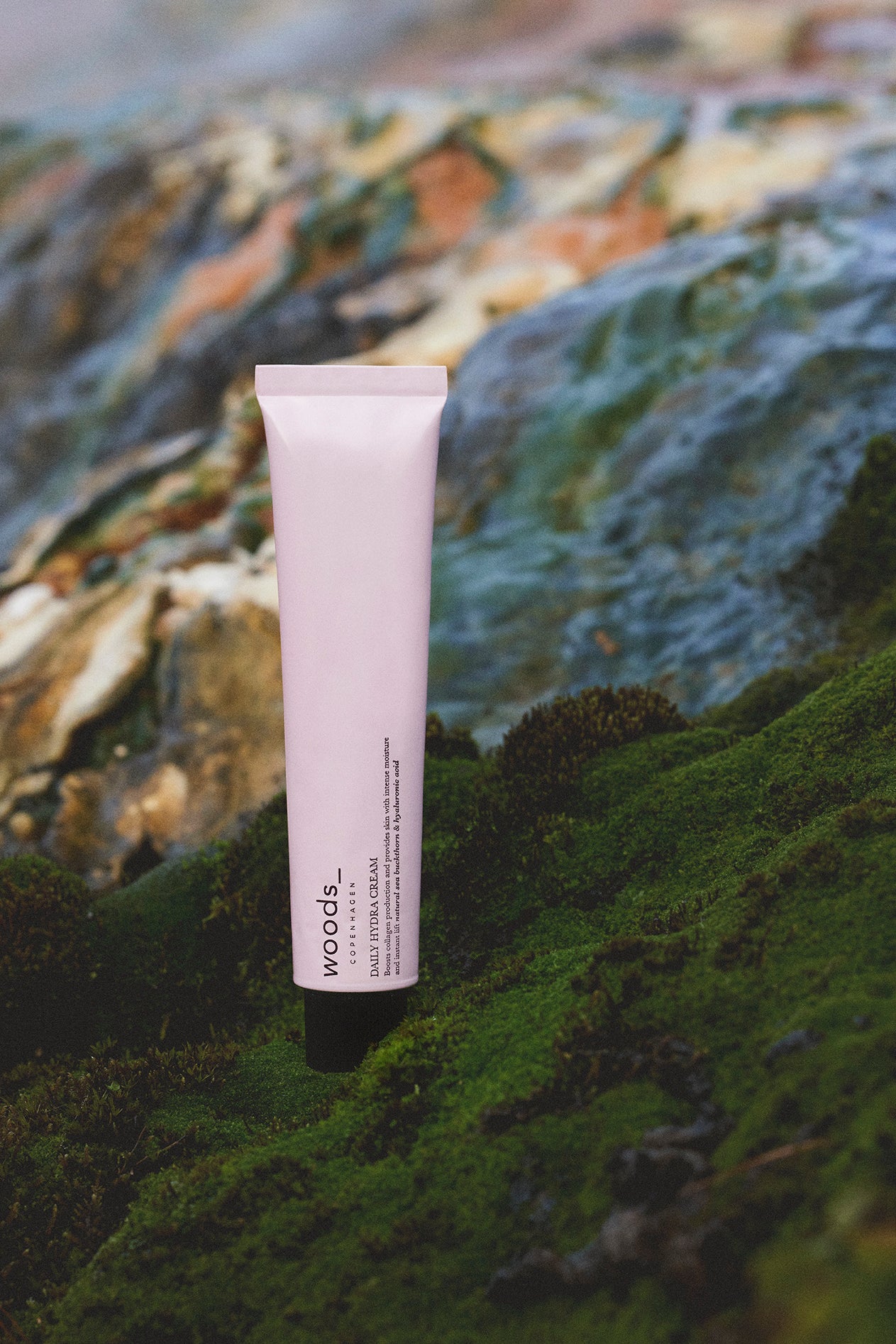 Woods Copenhagen Daily Hydra Cream in soft pink packaging, showcasing minimalist Scandinavian skincare design with natural, muted color palette