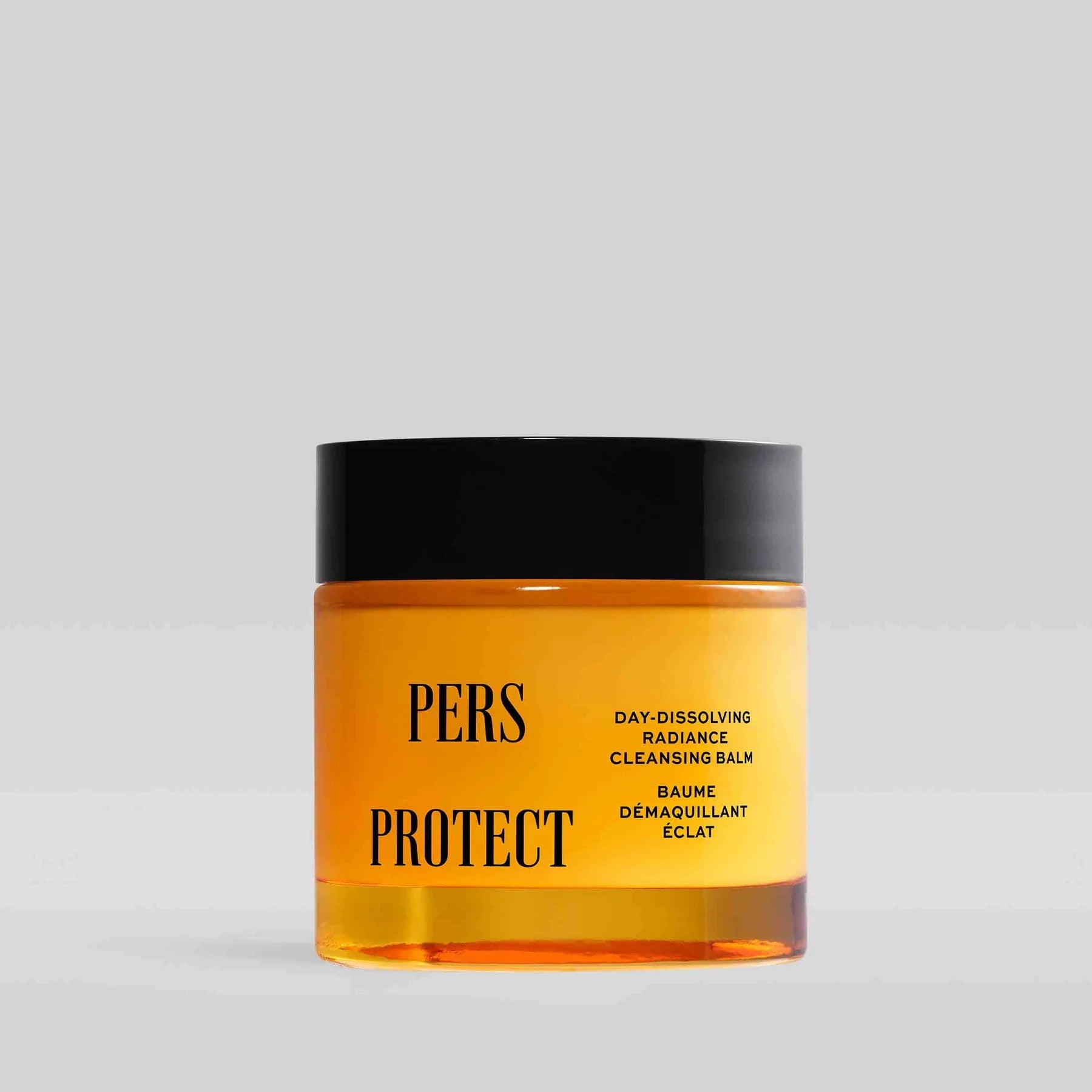 PERS Protect Day-Dissolving Radiance Cleansing Balm in vibrant yellow jar with black cap, showcasing minimalist skincare design