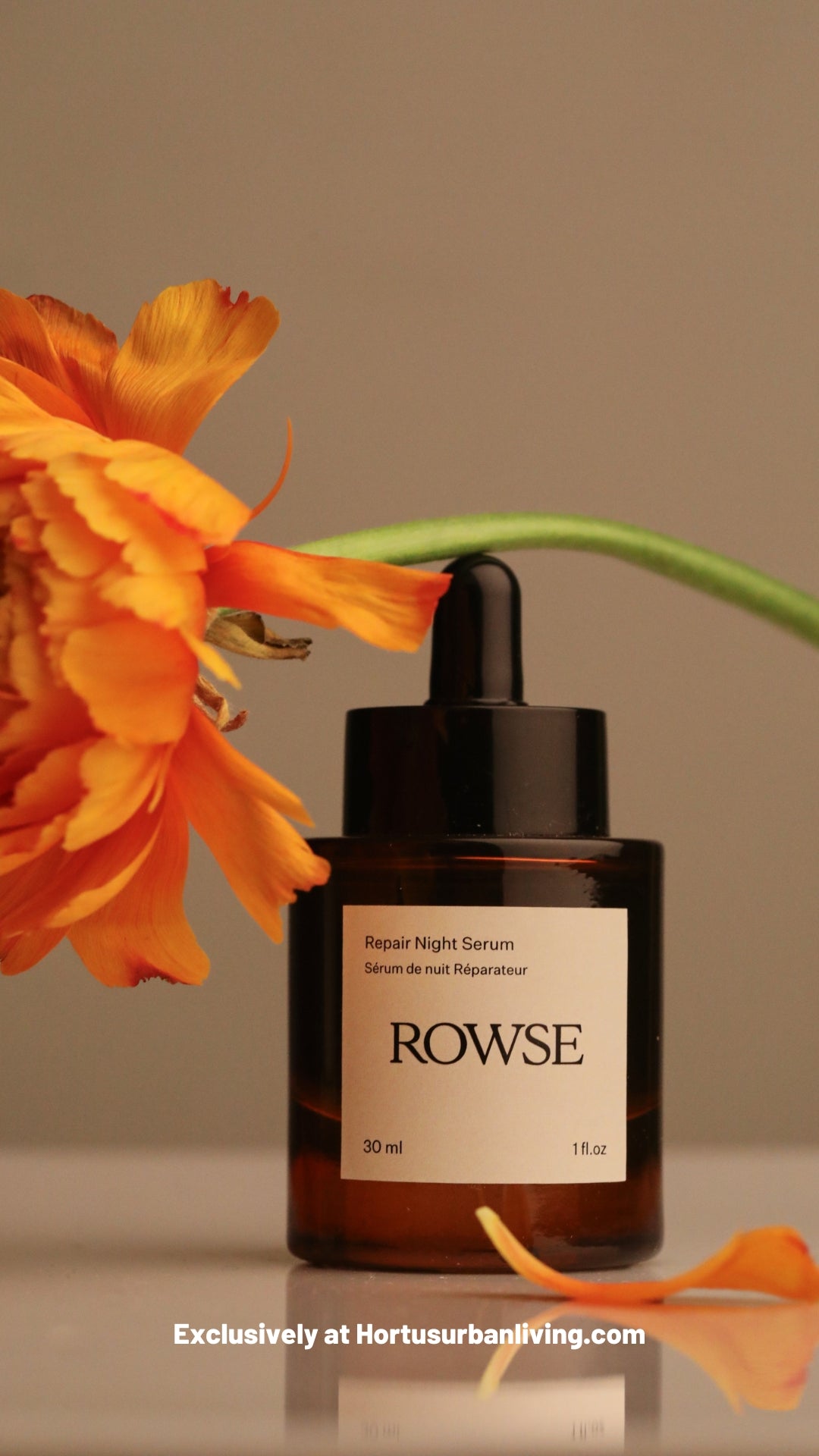 ROWSE Repair Night Serum, 30ml amber bottle elegantly styled with vibrant orange flower, highlighting nighttime skincare and natural botanical aesthetic
