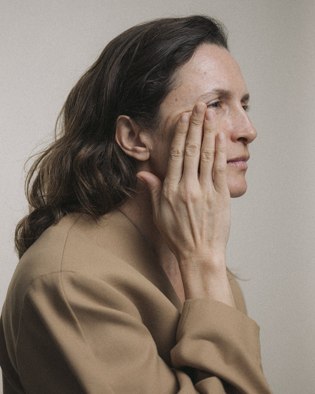 ROWSE skincare editorial featuring a contemplative woman in neutral tones, showcasing minimalist beauty and emotional depth
