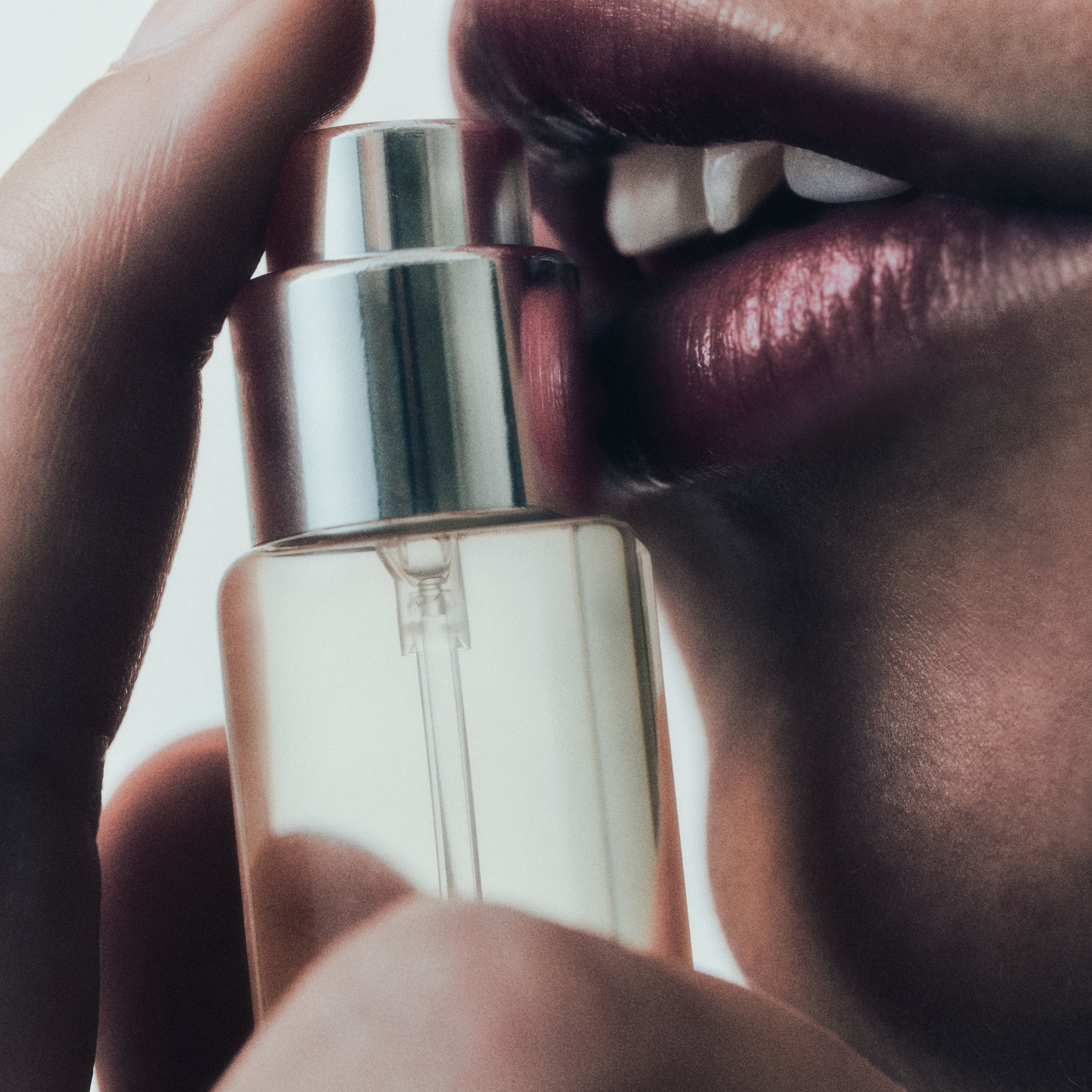 Selahatin oral spray in minimalist glass bottle, close-up editorial image with artistic lip and skin tones, showcasing product design
