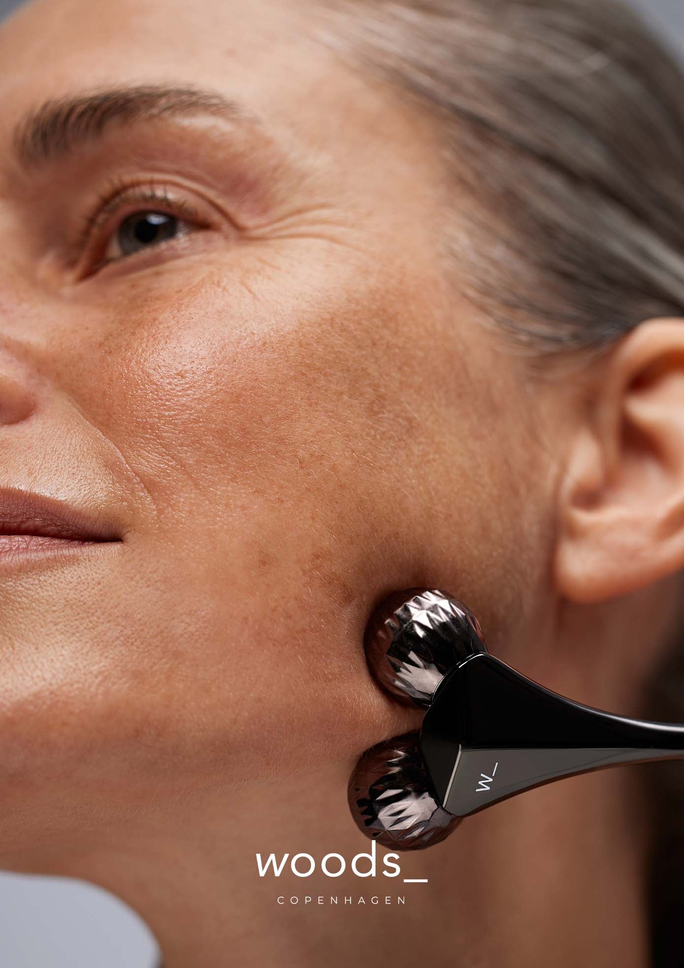 Woods Copenhagen Contouring Roller - precision facial massage tool with textured metallic heads, demonstrating advanced skincare technology and minimalist Scandinavian design